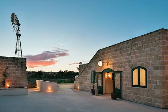 Farmhouse courtyard at dusk beneath the Maltese sky